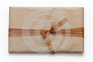 Parcel wrapping in brown craft paper and tie satin ribbon. Package. Delivery service. Online shopping. Your purchase. Gift box on