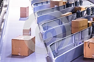 Parcels on conveyors with blurred industrial background photo