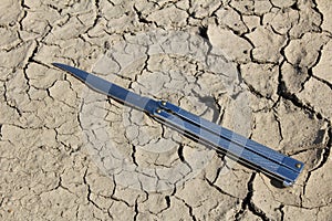 Parched ground and butterfly knife