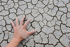 Parched land with hand scattering dry dirt