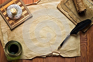 Parchment paper with quil pen and ink lit by candle