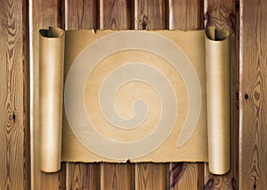 Parchment scroll on wooden background