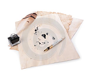 Parchment with stains of ink, feather pen and inkwell on white background