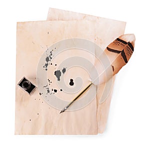 Parchment with stains of ink, feather pen and inkwell on white background, top view