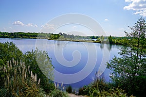 Parempuyre blue water Lake reflexion trees in Gironde france