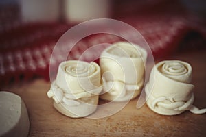 Parenica, traditional Slovak cheese rolls on wooden table background. Home made rolled cheese, sheep milk product