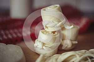 Parenica, traditional Slovak cheese rolls on wooden table background. Home made rolled cheese, sheep milk product