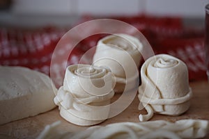 Parenica, tradičné slovenské syrové rolky na pozadí dreveného stola. Domáci točený syr, výrobok z ovčieho mlieka