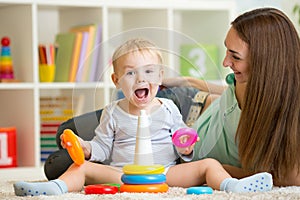 Parent and child boy playing together at home photo