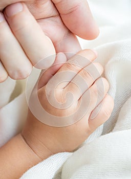 Parent and daughter holding hand