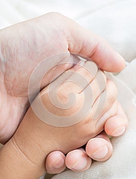 Parent and daughter holding hand