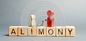 The parent is handcuffed to the child and the word alimony. The concept of parental debt. Alimony payment. Custody, care and photo