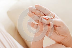 Parent hands holding newborn baby fingers, Close up mother`s hand holding their new born baby. Love family healthcare and medical