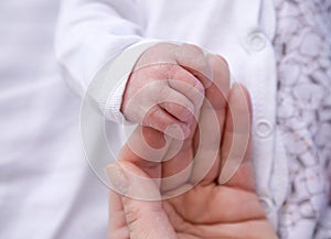 Parent hands holding newborn baby fingers. Mother& x27;s hand holding newborn baby. Love family healthcare