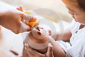 Parent helping her child perform first aid knee injury