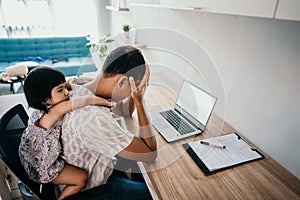 Parent interrupts by her daughter while working in the office