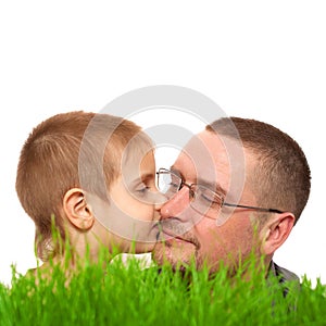 Parent kid kiss father's day green grass white