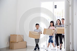 Parent and kids with cardboard box. moving to new house