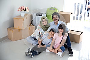 Parent and kids with cardboard box. moving to new house