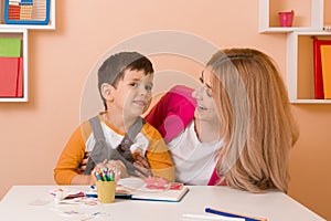 Parent learning and playing with kids. Mother or teacher learning english letters with children.Homeschooling