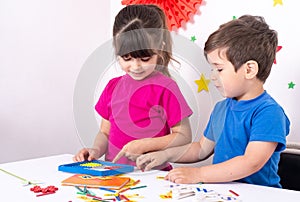 Parent learning and playing with kids. Mother or teacher painting or learning english letters with children.Homeschooling