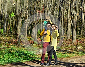 Parent with little baby son play with paper plane toy in park, traveling concept. Traveling by plane. Flight is what