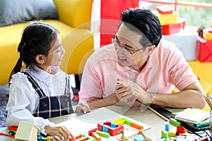 Parent and little child having fun playing educational toys,Family concept