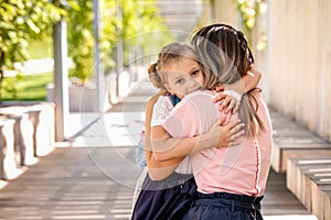 Parent mother taking child to school. Pupil girl of primary school go study with blue backpack outdoors. Back to school. First day