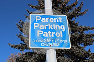 Parent Parking Patrol Sign Against Tree and Blue Sky