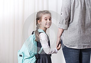 Parent and primary school student go hand in hand photo