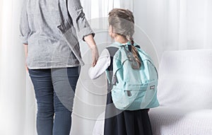 Parent and primary school student go hand in hand photo