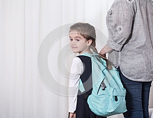 Parent and primary school student go hand in hand photo