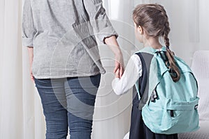 Parent and primary school student go hand in hand photo