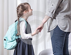 Parent and primary school student go hand in hand photo