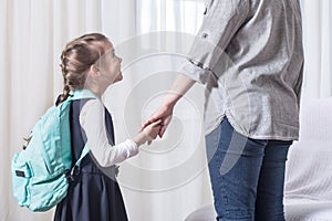 Parent and primary school student go hand in hand photo