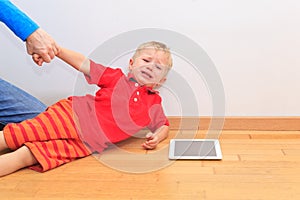 Parent pulling child from touch pad