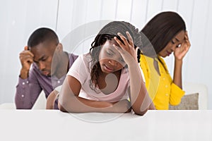 Parent Quarreling Behind Girl Covering Her Ears