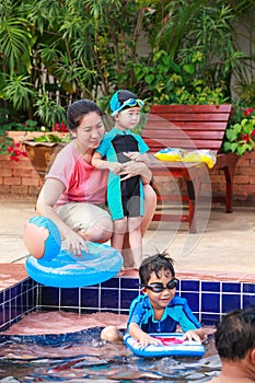 Parent and sibling playing outdoors. Summer vacation concept