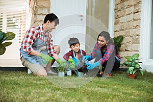 Parent and son gardening activity outdoor in the garden house