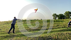 Parent spending leisure with son at countryside at sunset