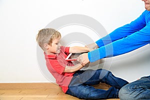 Parent taking out touch pad from child photo