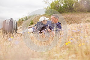 Parent talking child nature lying grass meadow