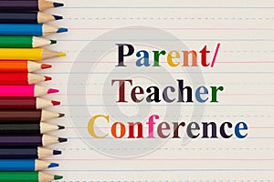 Parent Teacher Conference message with color pencils on vintage ruled line notebook paper