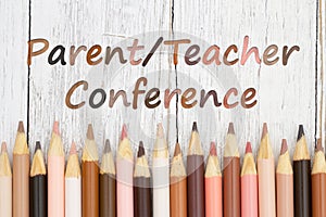 Parent Teacher Conference message with multiculture skin tone color pencils photo