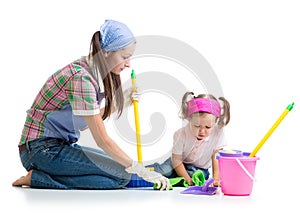 Parent teaches daughter child cleaning room