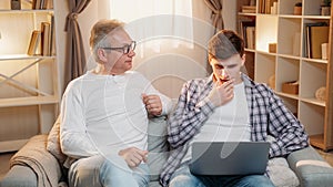 Parent teaching family support father laptop son