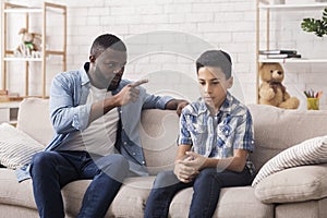 Parent Violence. Angry Black Father Scolding His Upset Innocent Son