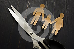 Parental alienation concept. Figures of family and scissors as symbol of divorce.