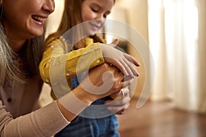 Parental love and care. Girl and woman holding hands together