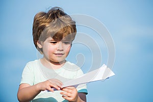 Parenthood and childhood concept. Dreams of traveling. Happy kid on summer field - dream of flying concept. Happy child